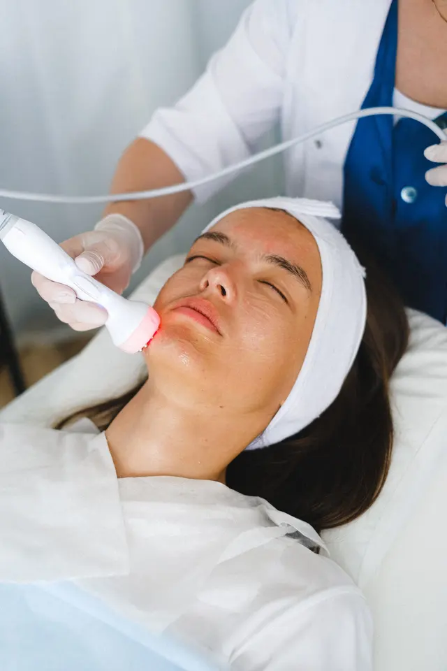 Patient receiving a gentle light-based facial treatment