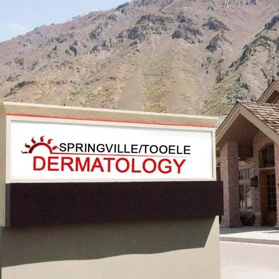 Springville/Tooele Dermatology sign in front of the office with mountains behind