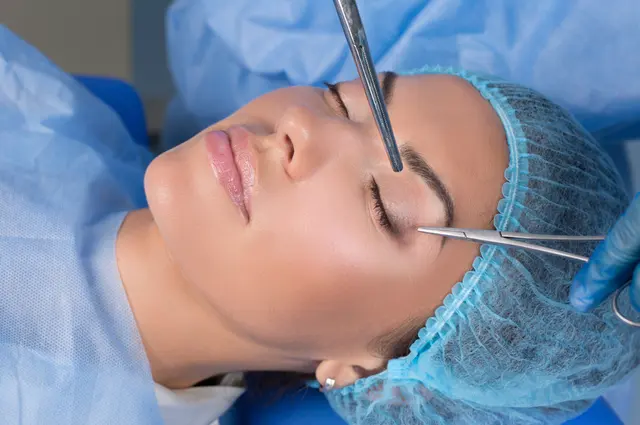 Patient in a surgical cap during an in-office dermatologic procedure